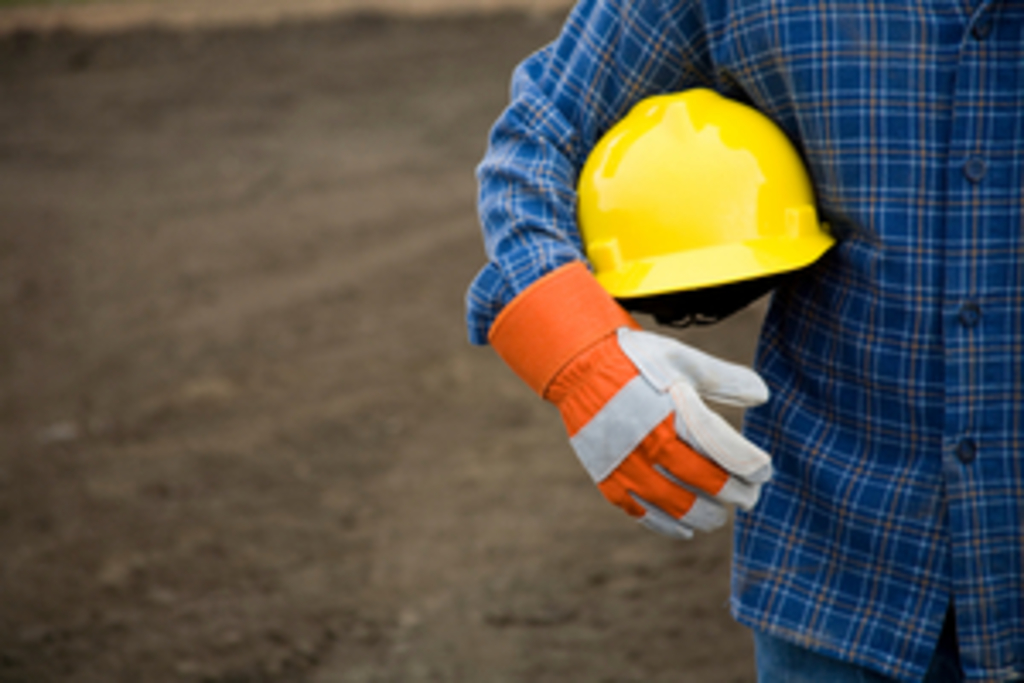 holding hard hat construction ppe